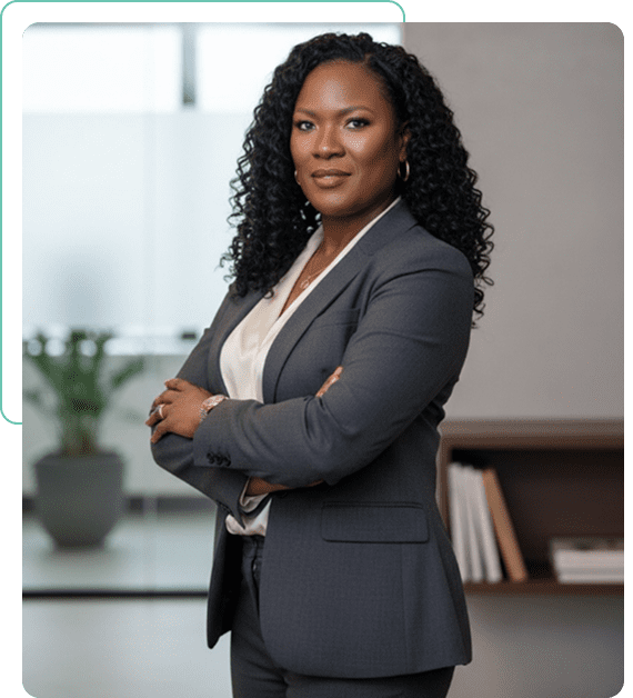 Confident businesswoman in a gray suit with arms crossed.